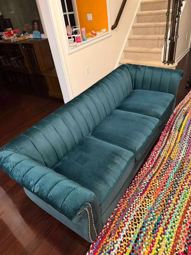 The same teal sofa after cleaning, clean and even in color